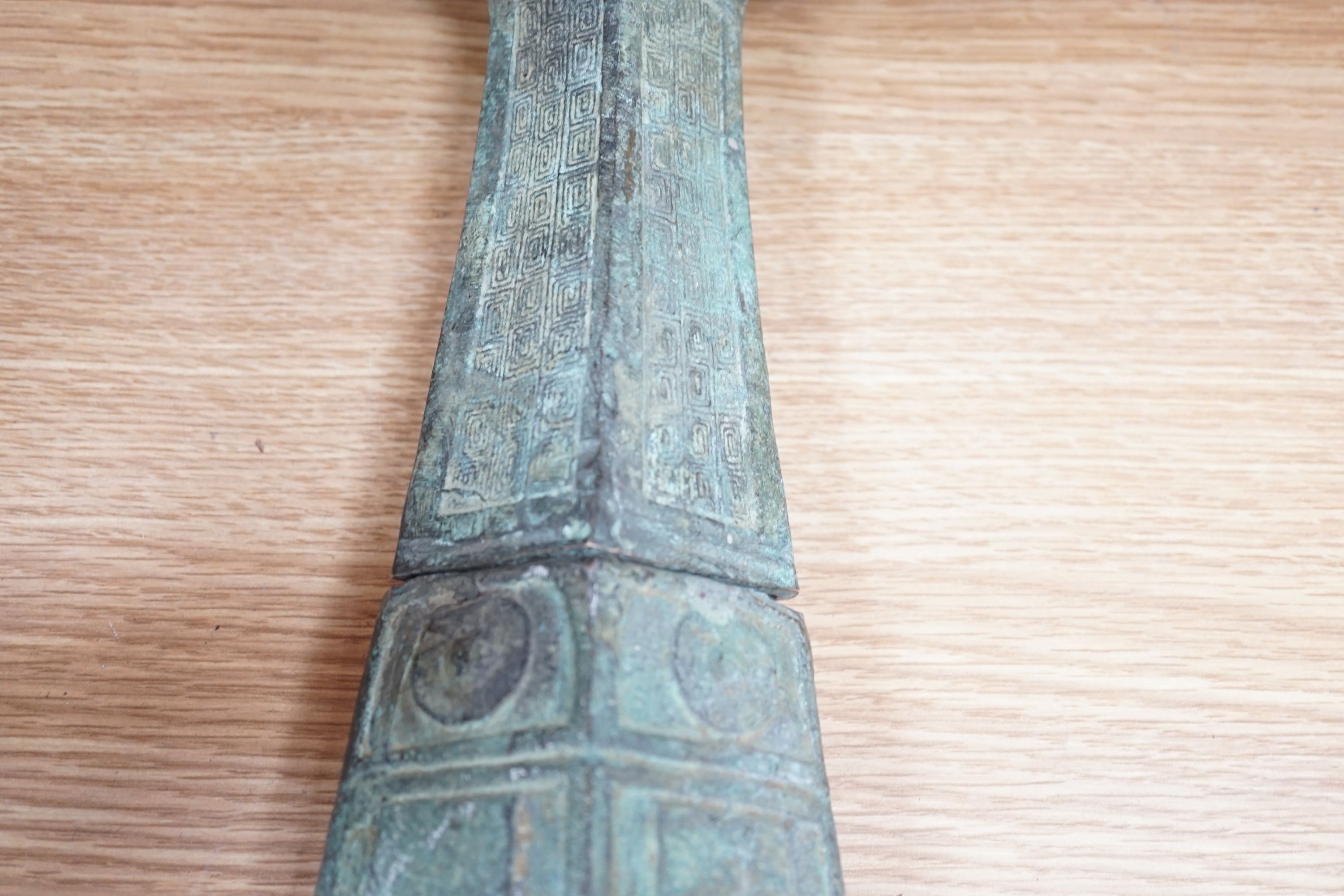 A large, archaic tic bronze figure, 76cm, and a bronze bell on chain